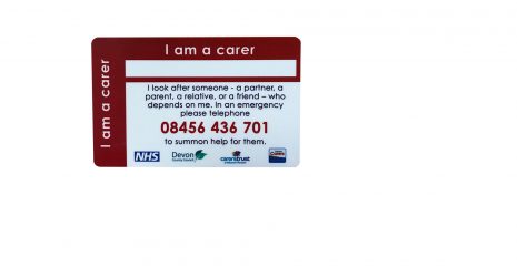 An image of the Carers Alert card. It is a red card with the words 'I am a carer' on it. If found in an emergency, the person that finds the card can ring the phone number on the card and alert the authorities that there is a cared for person that needs looking after.